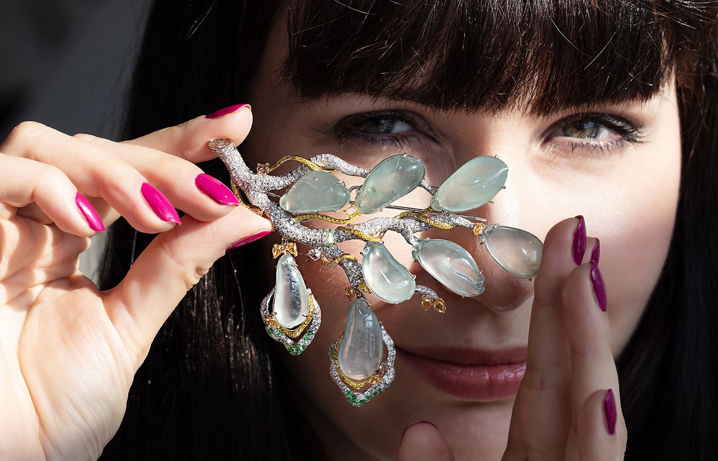 Katerina Perez holds a pristine jewel up to the light