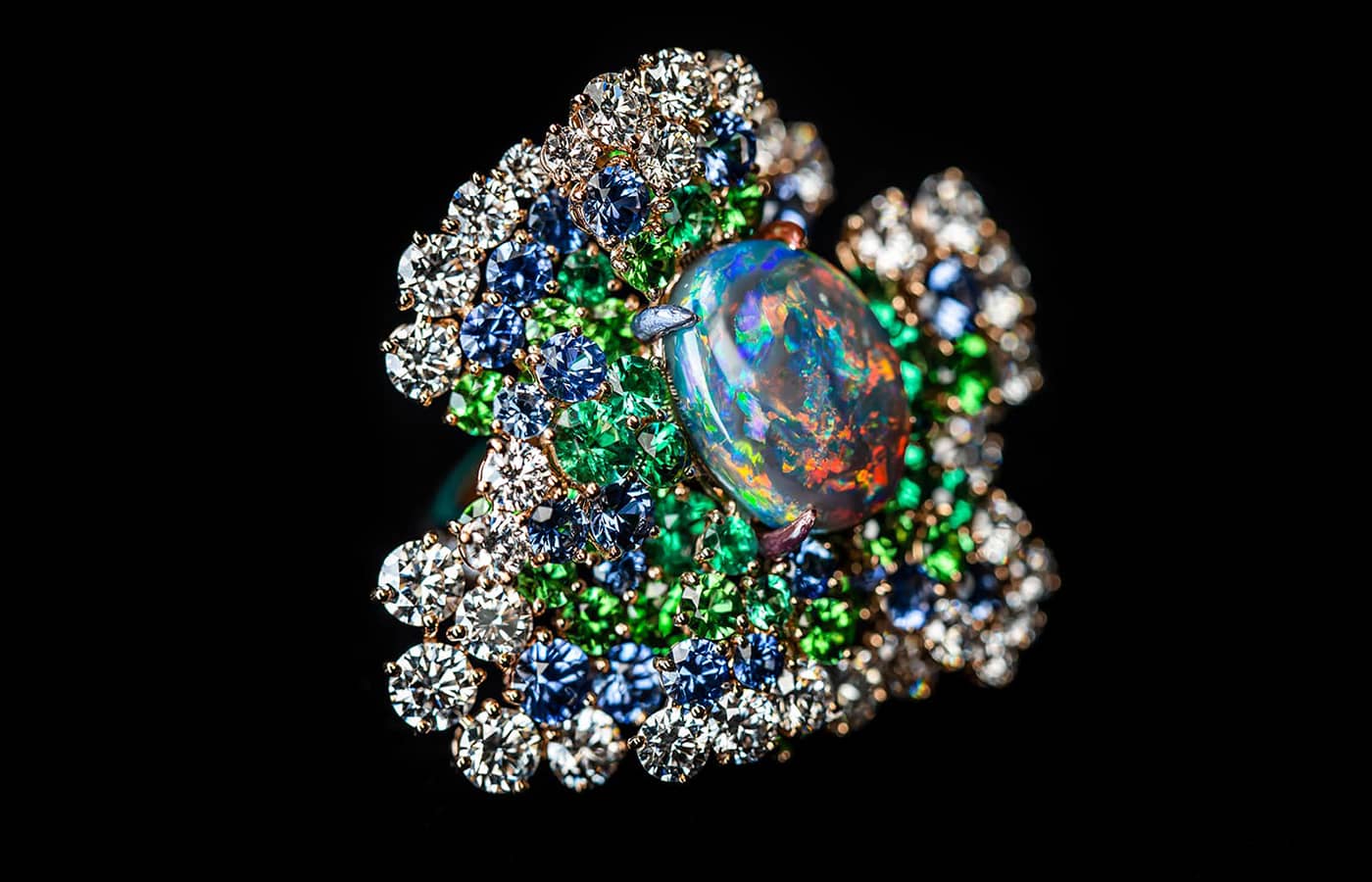 Close up of the Dior Joaillerie Rose necklace in white and rose gold, diamonds, black opal, tsavorite garnets, sapphires, emeralds, purple, red, green and blue lacquers from the Dearest Dior High Jewellery collection