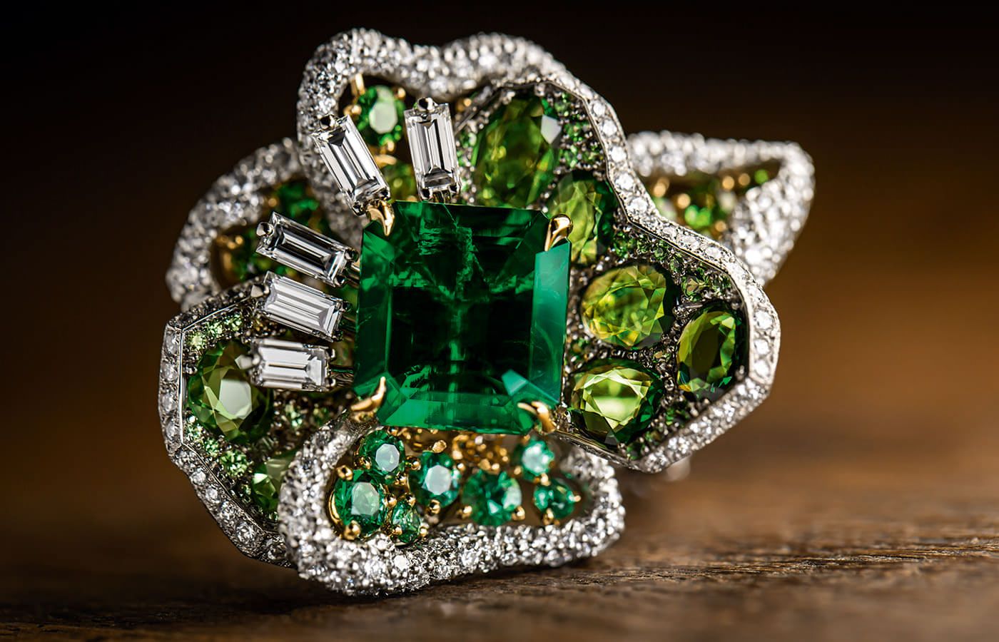  Close up of the Dior Joaillerie Rose ring in white gold, yellow gold, platinum, diamonds, emeralds and tsavorite garnets from the Dearest Dior High Jewellery collection