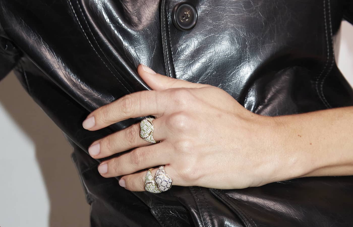 Model wearing Yvonne Leon Chevalière Mini Coeur rings in white gold, yellow gold and diamonds