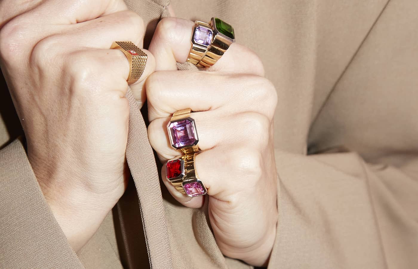  Model wearing gold, coloured gemstones and amethyst rings by Yvonne Leon