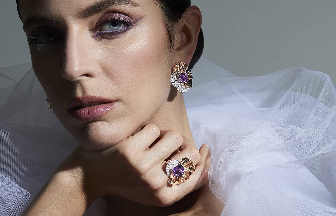 Model wearing gold, amethyst and diamond earrings and ring by Palmiero Jewellery Design