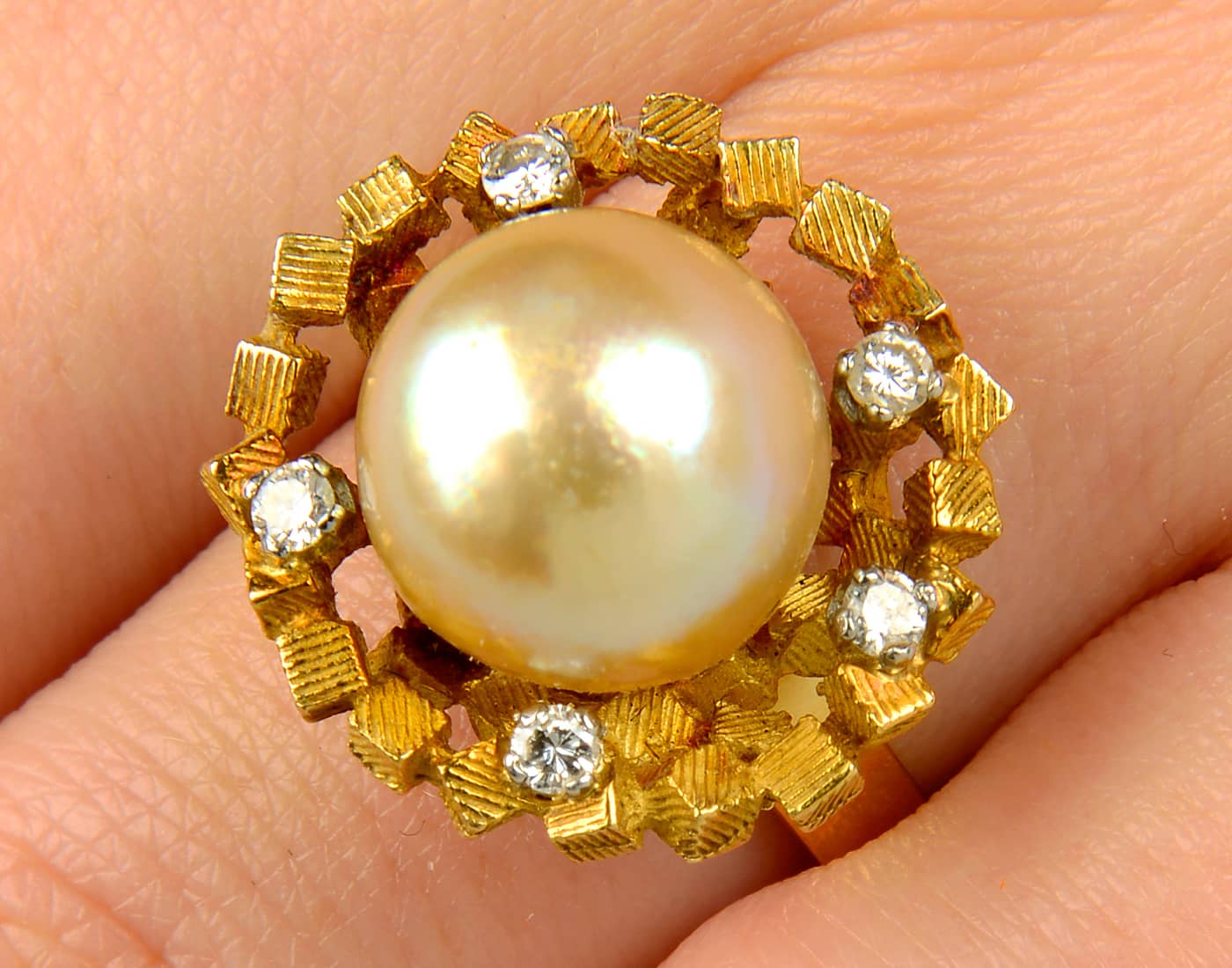  A 1960s gold cultured pearl ring, with brilliant-cut diamond highlight textured cuboid mount by John Donald