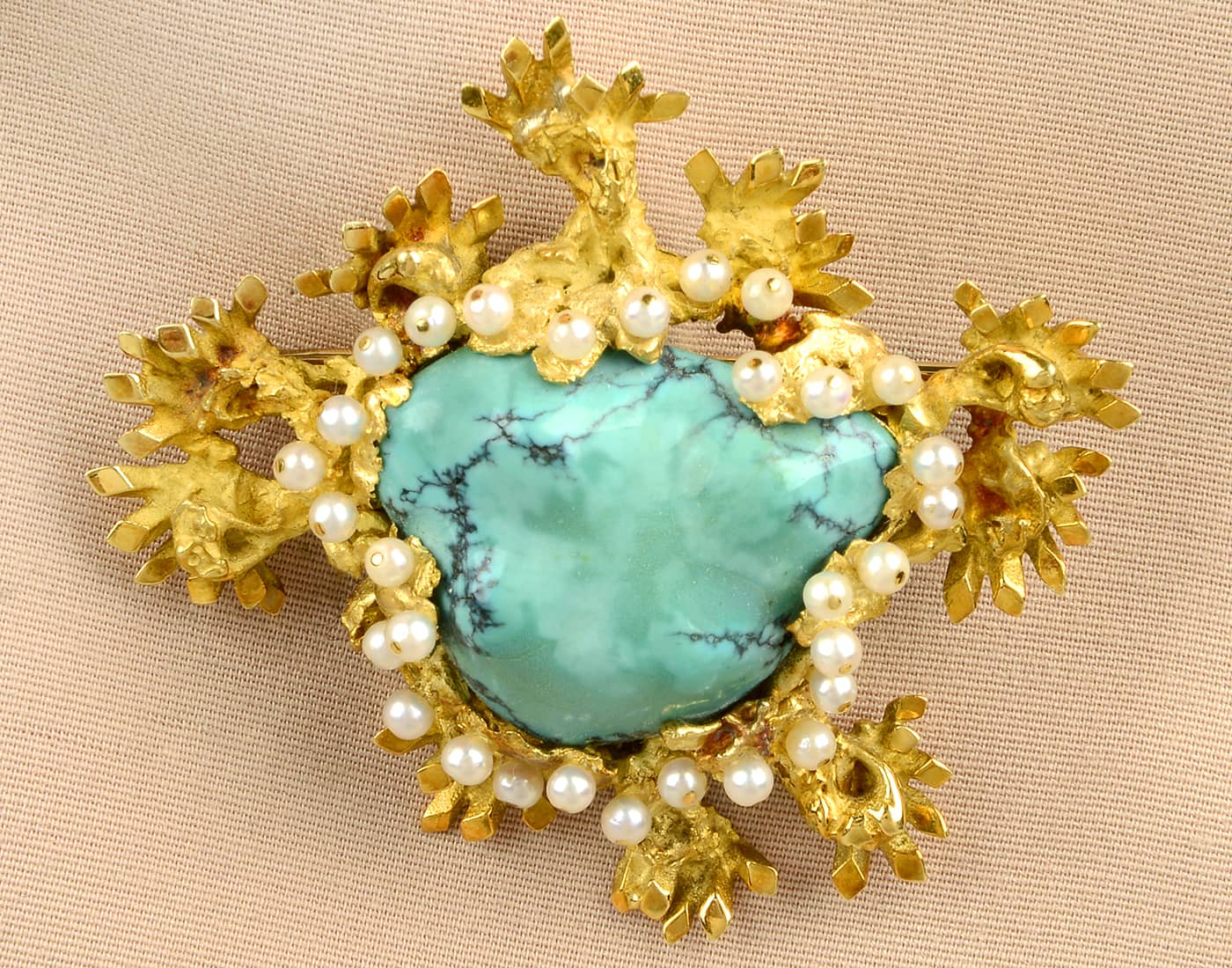 A 1960s gold turquoise and seed pearl abstract brooch by John Donald