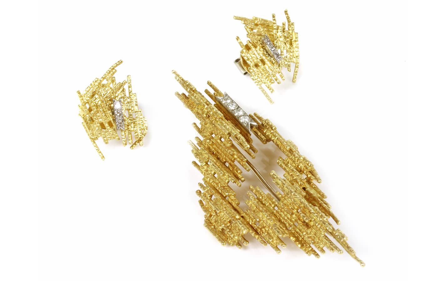  A gold diamond set brooch and earring suite, C. 1970-1972 by Andrew Grima