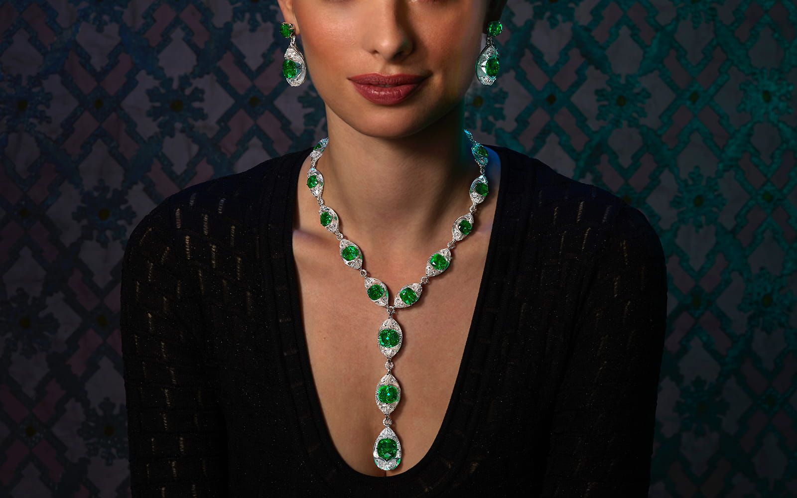 Model wearing a Moussaieff High Jewellery suite in white gold, rock crystal, emerald and diamond