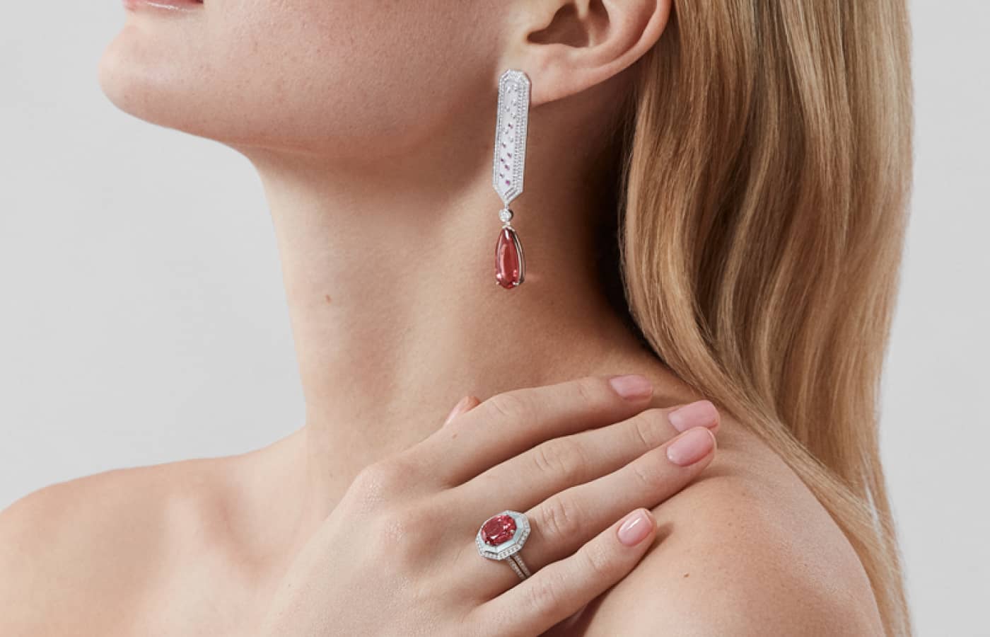  Model wearing Garrard Desert Rose earrings and ring in white gold, pink tourmaline, diamond, pink sapphire and white mother-of-pearl from the Couture High Jewellery collection 