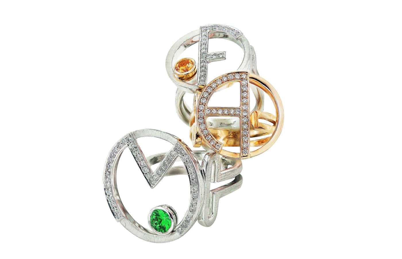 Caratell Letter rings in gold, white gold, emerald and diamond