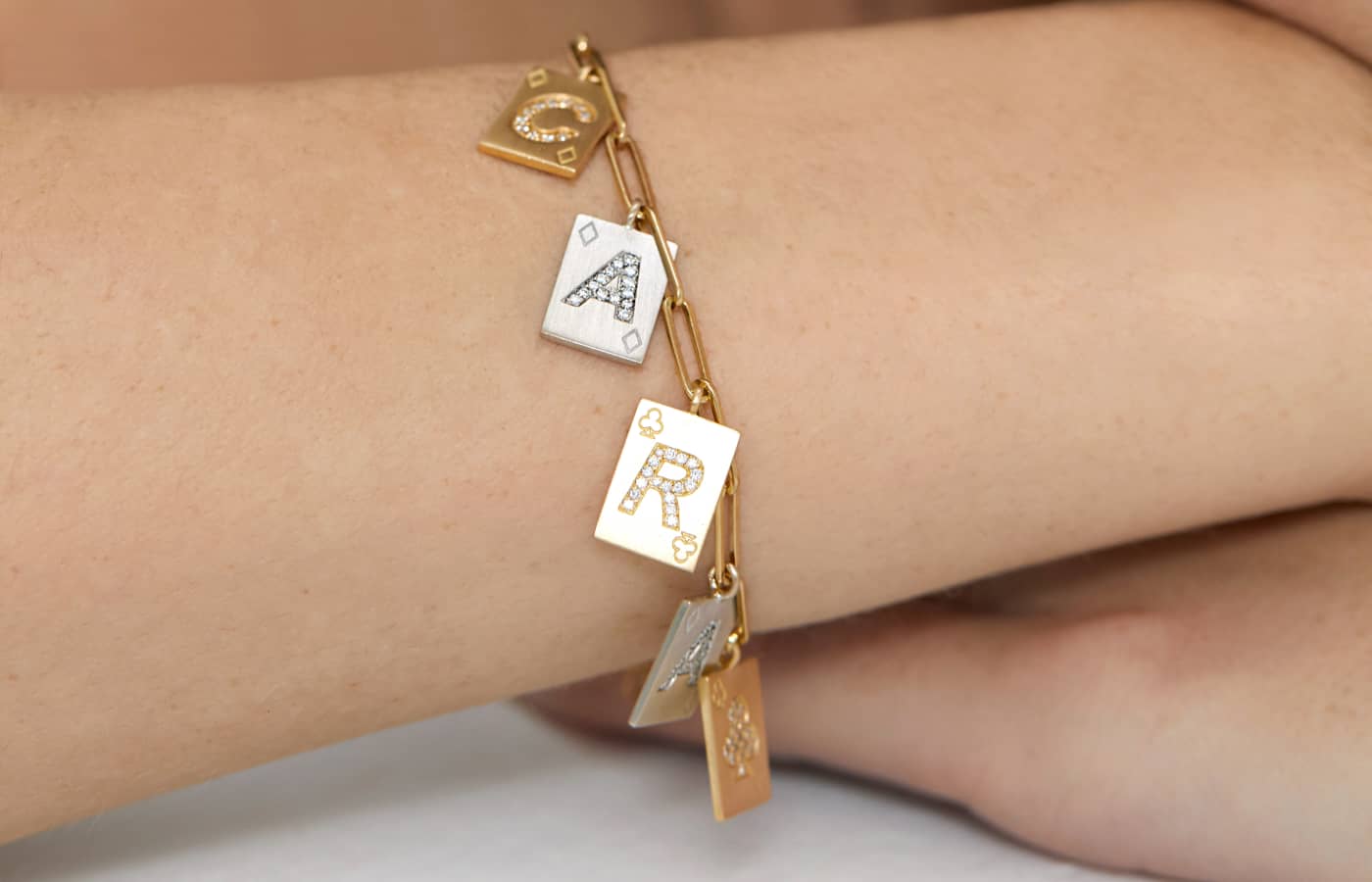  Model wearing Mystery Joy Charm bracelet in gold, white gold and diamond 