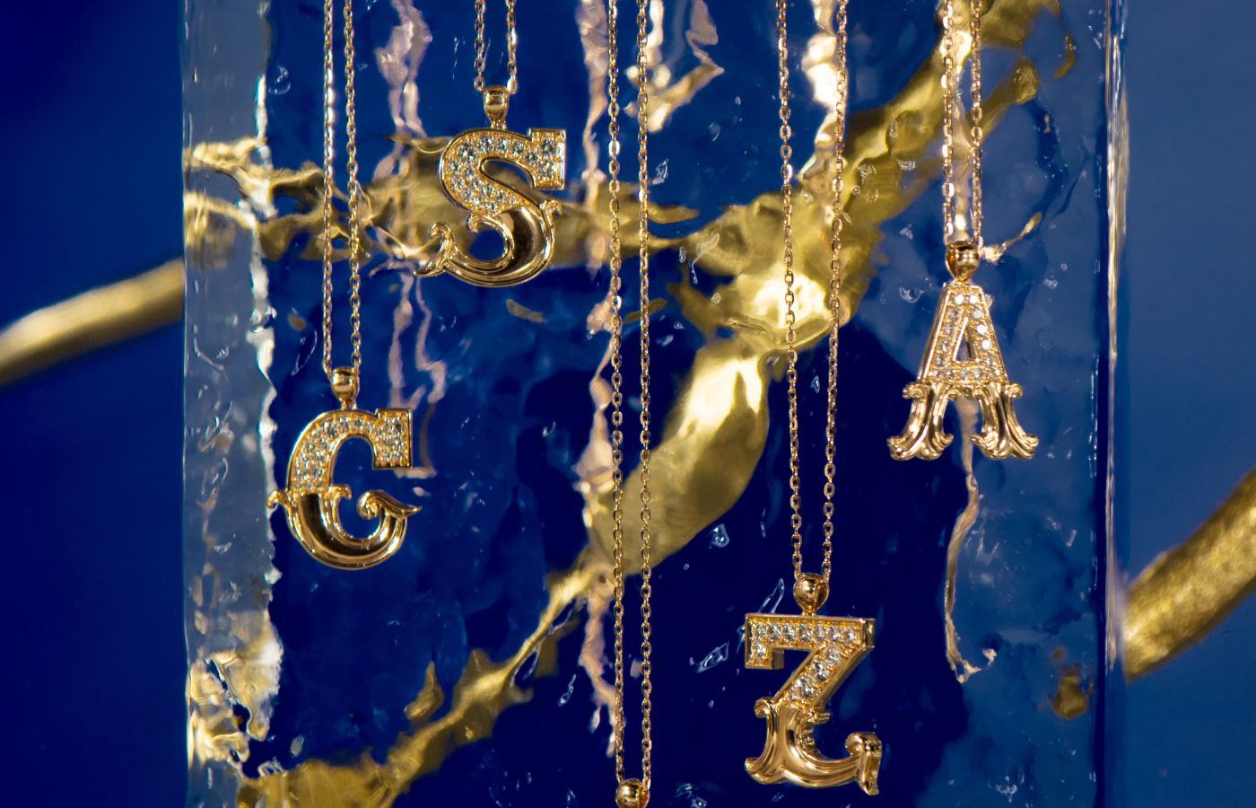 Toktam letter pendants in Gold