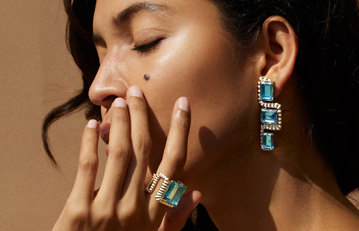  Model wearing Emily P. Wheeler earing and ring in gold, aquamarine and diamond