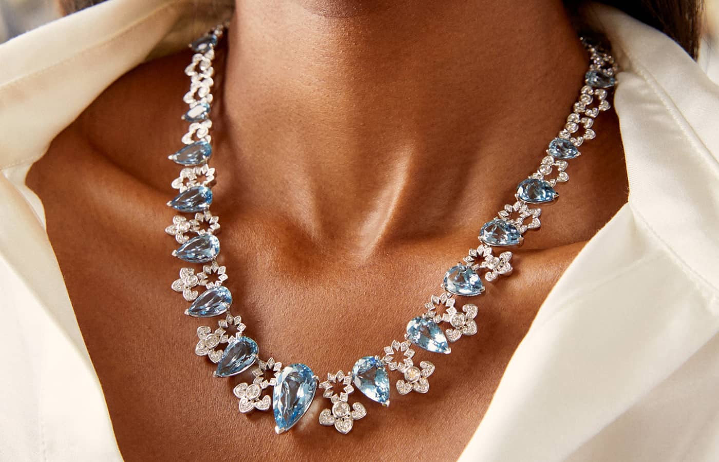  Model wearing Boodles necklace in white gold, aquamarine and diamond