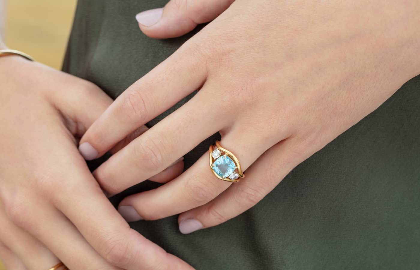  Model wearing Minka Jewels rings in gold and aquamarine