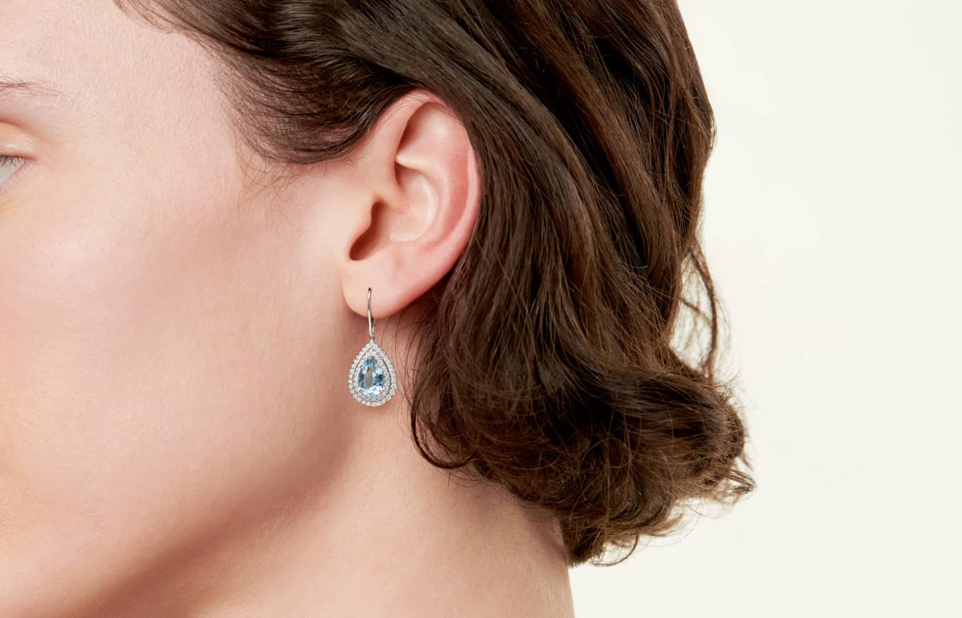  Model wearing Tiffany & Co. drop earring in white gold, aquamarine and diamond