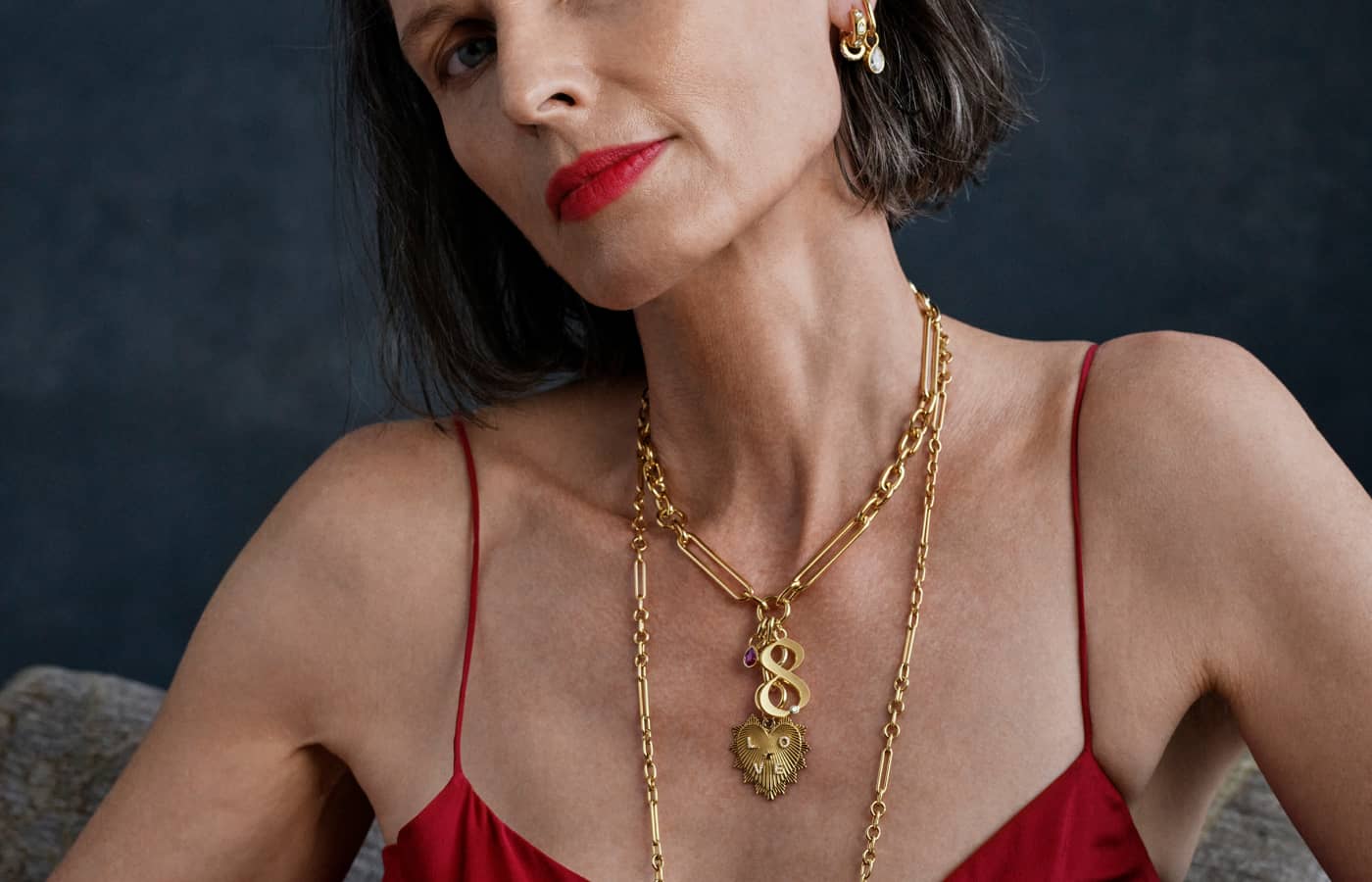 Model wearing Foundrae neck and ear charms in gold