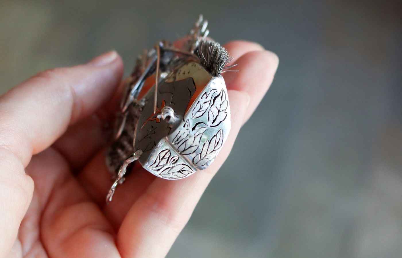  A closer look at the details on the Ricardo Basta zebra brooch with white and black diamonds in palladium 