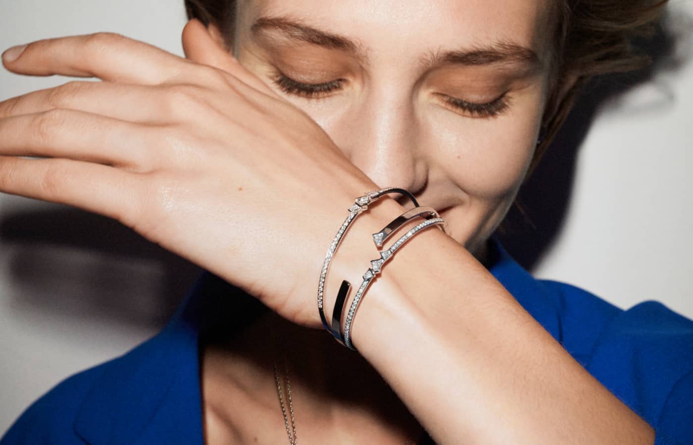  A model wears Rock Diamonds bracelets in 18k yellow and white gold by Bucherer Fine Jewellery with trapezoid- and round brilliant-cut diamonds