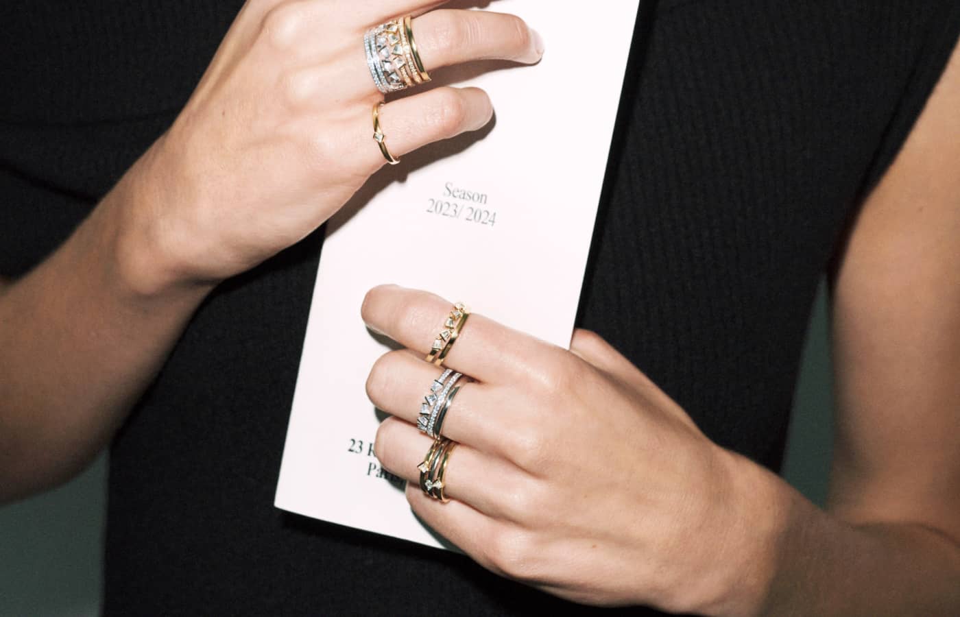  A model wears Rock Diamonds rings in 18k white and yellow gold by Bucherer Fine Jewellery with trapezoid- and round brilliant-cut diamonds