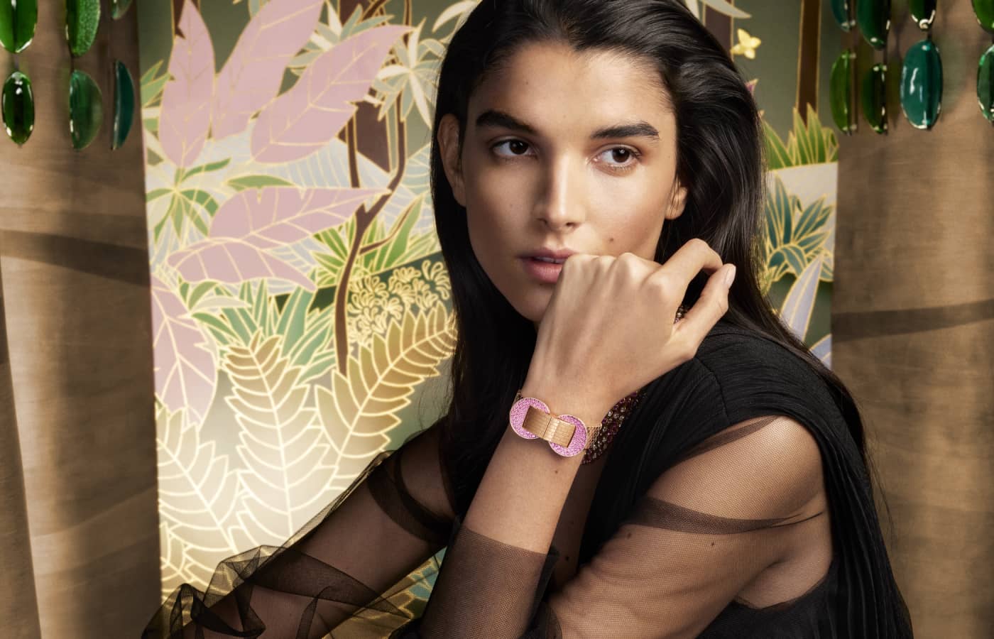 Model wearing Van Cleef & Arpels Ludo Secret watch in rose gold, pink sapphires and guilloché white mother-of-pearl with a Swiss quartz movement