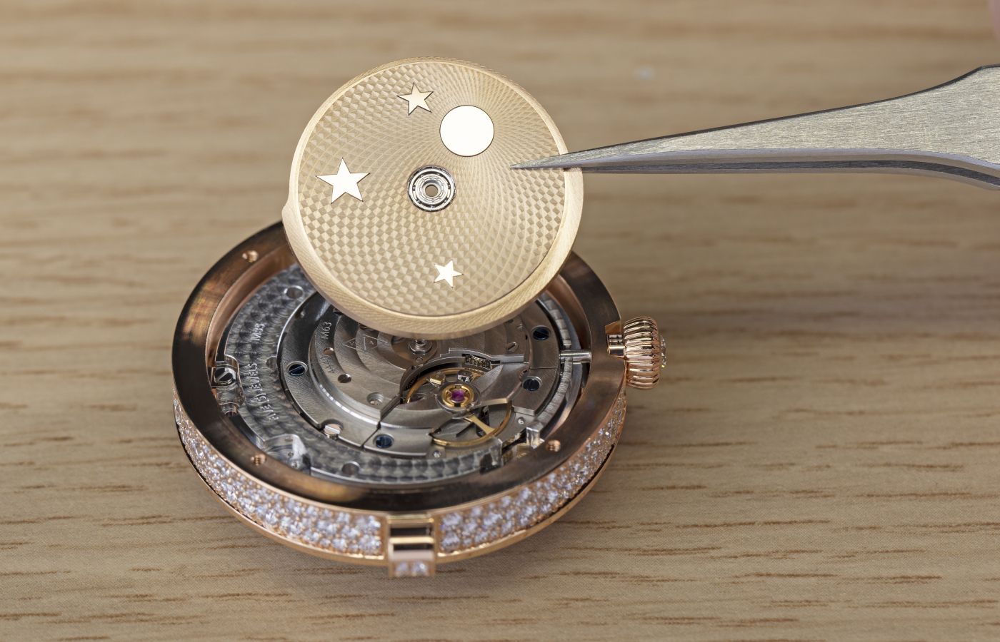  Assembling the mechanisms for the Van Cleef & Arpels Lady Féerie Or Rose watch  in rose gold,  pink sapphire, white mother-of-pearl, opaque and plique-à-jour enamel and diamond 