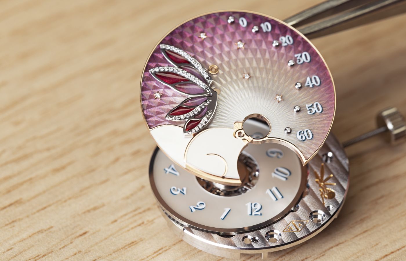  Assembling the mechanisms for the Van Cleef & Arpels Lady Féerie Or Rose watch  in rose gold,  pink sapphire, white mother-of-pearl, opaque and plique-à-jour enamel and diamond 