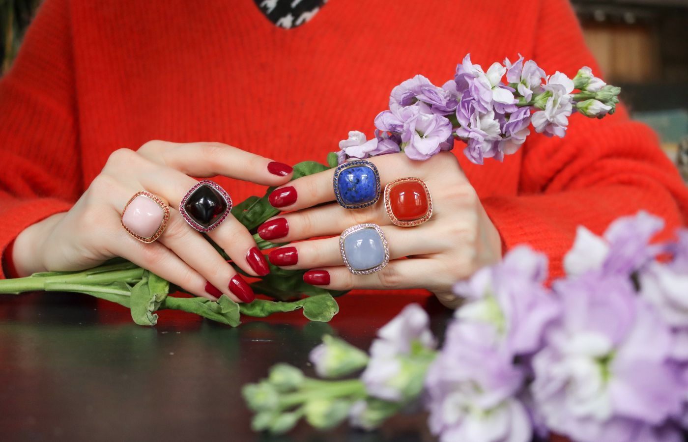 Katerina Perez wears Charlotte Reedtz Jewellery Magic Wish rings with vibrant gemstone cabochons and haloes