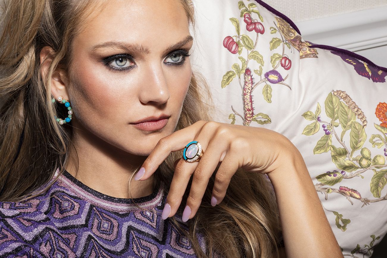 Model wearing Mason and Books earrings and ring in gold, turquoise, opal, pearl and diamond