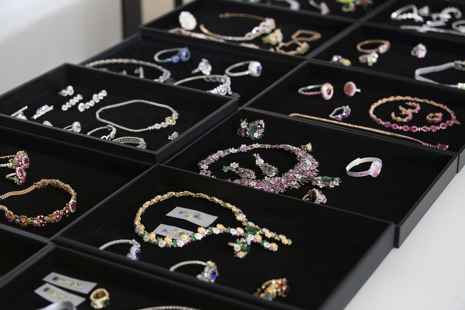 Trays displaying pieces from the Les Jardins de la Couture High Jewellery collection by Dior Joaillerie 