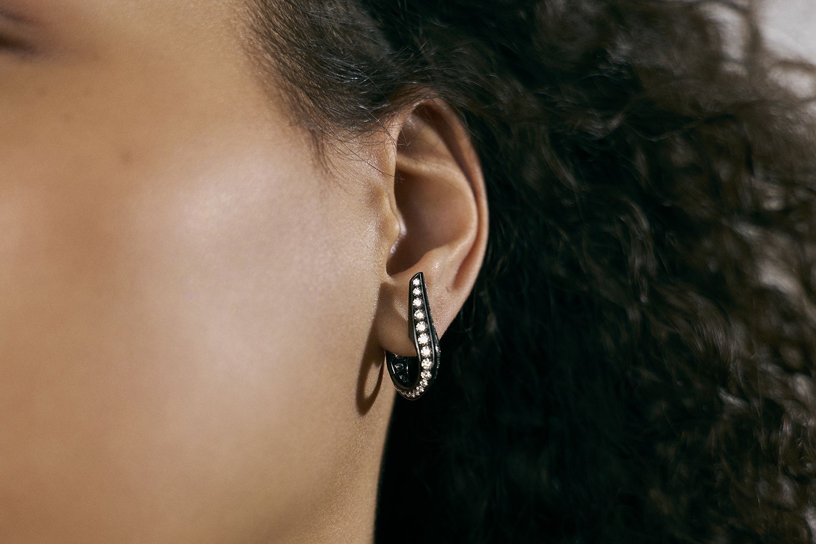  Model wearing a Repossi limited edition earring in blackened gold and diamond