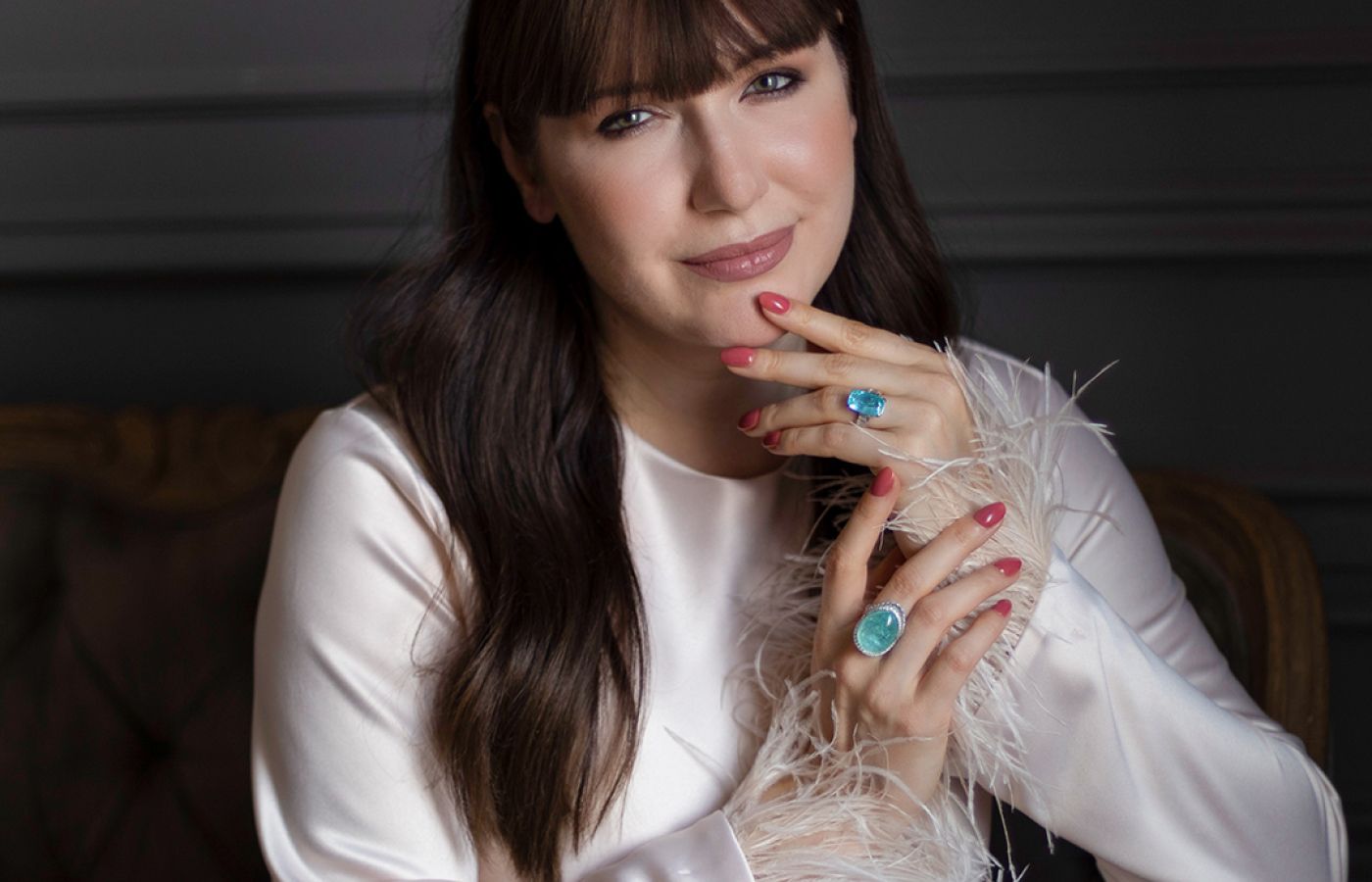 Katerina Perez wearing a pair of Parure Atelier High Jewellery rings featuring a 39.34-ct cabochon Paraiba tourmaline and a 7.82-ct Paraiba tourmaline 