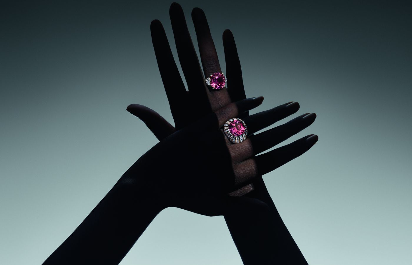  Model wearing Louis Vuitton Volcano High Jewellery rings in gold, platinum, a 9.31-ct cushion-cut pink tourmaline, a 20.70-ct cushion-cut tourmaline, V Monogram Star cut diamonds and diamonds from the Deep Time High Jewellery Collection