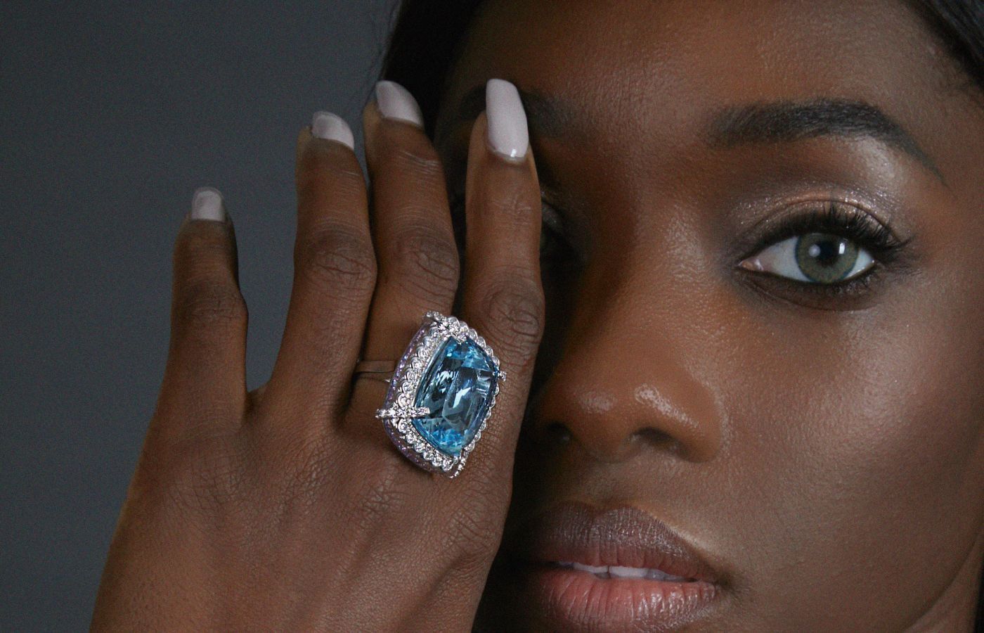  Sunita Nahata Icy Blue aquamarine ring set against a frame of pink sapphires