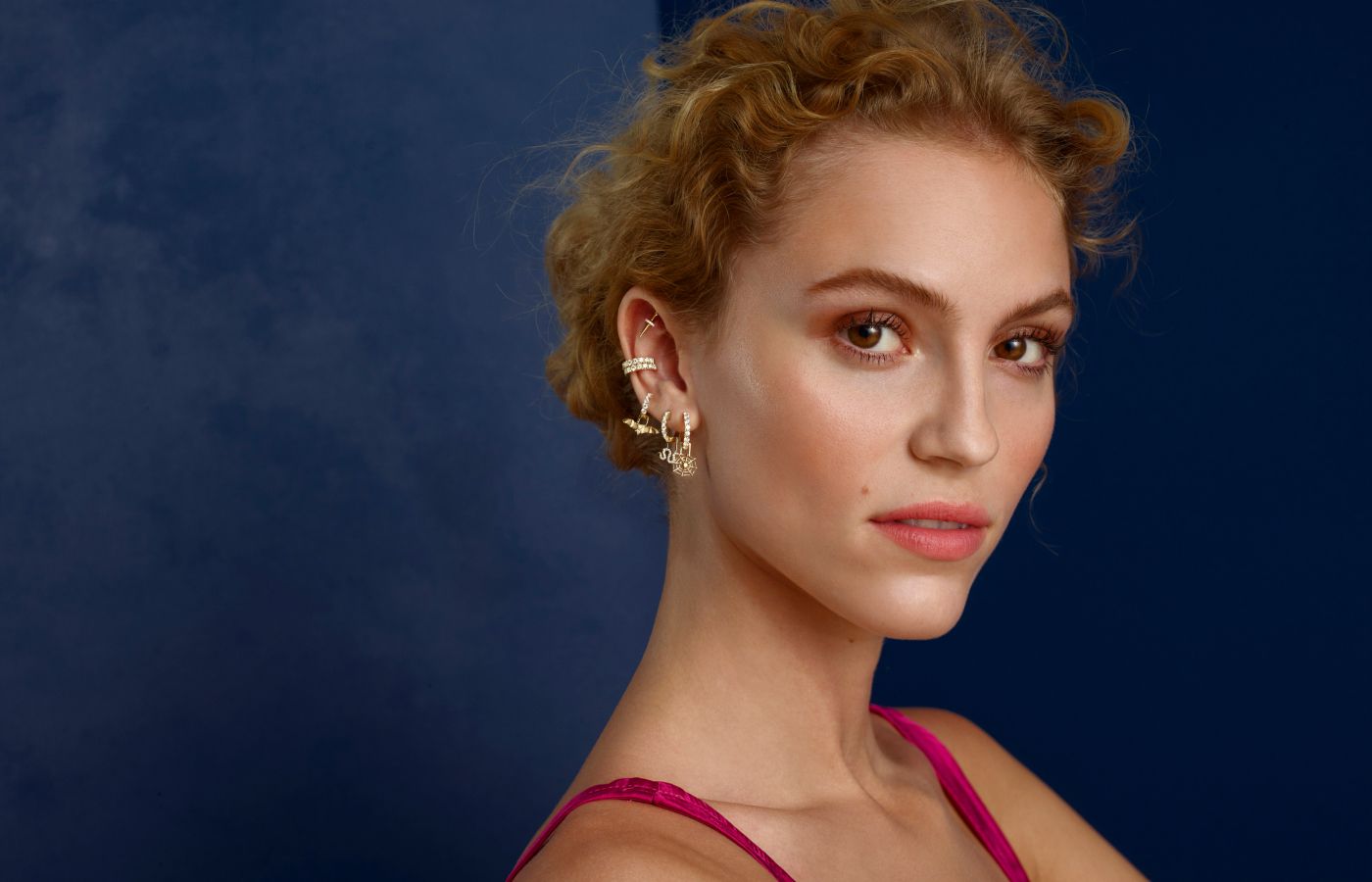  A model wears EarMenu creations with diamonds in 14k yellow gold by Robinson Pelham