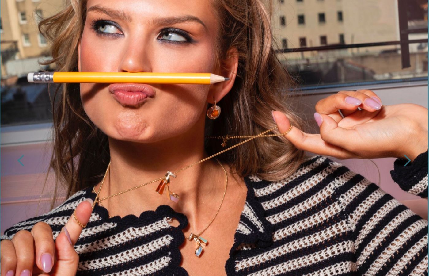 Model wearing Mason and Books Rise Up pendants in gold and precious gemstones