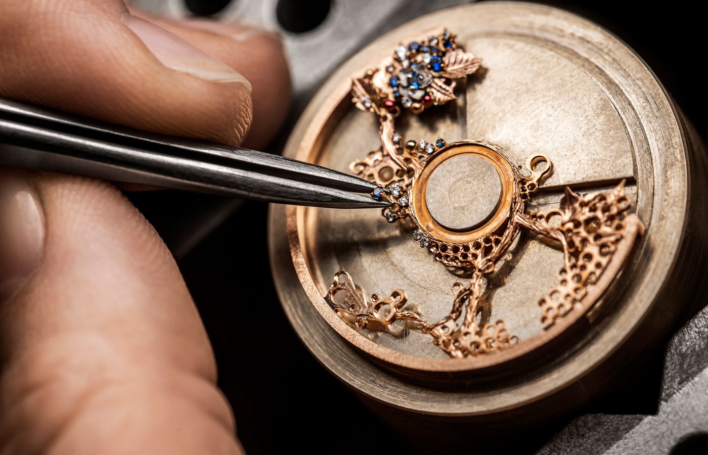  In house craftsmen setting the red and blue precious gemstones within the Dior Grand Bal Milly La Nuit High Jewellery watch dial