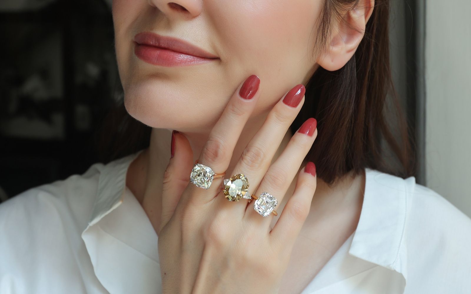 Katerina Perez wearing a selection of Antique rings at Hancocks including a 13.06-ct Old Mine Cushion-cut diamond Solitaire ring, an11.15-ct Fancy Deep colour Old-cut oval diamond ring, and a 9.01-ct Asscher-cut diamond Solitaire ring 