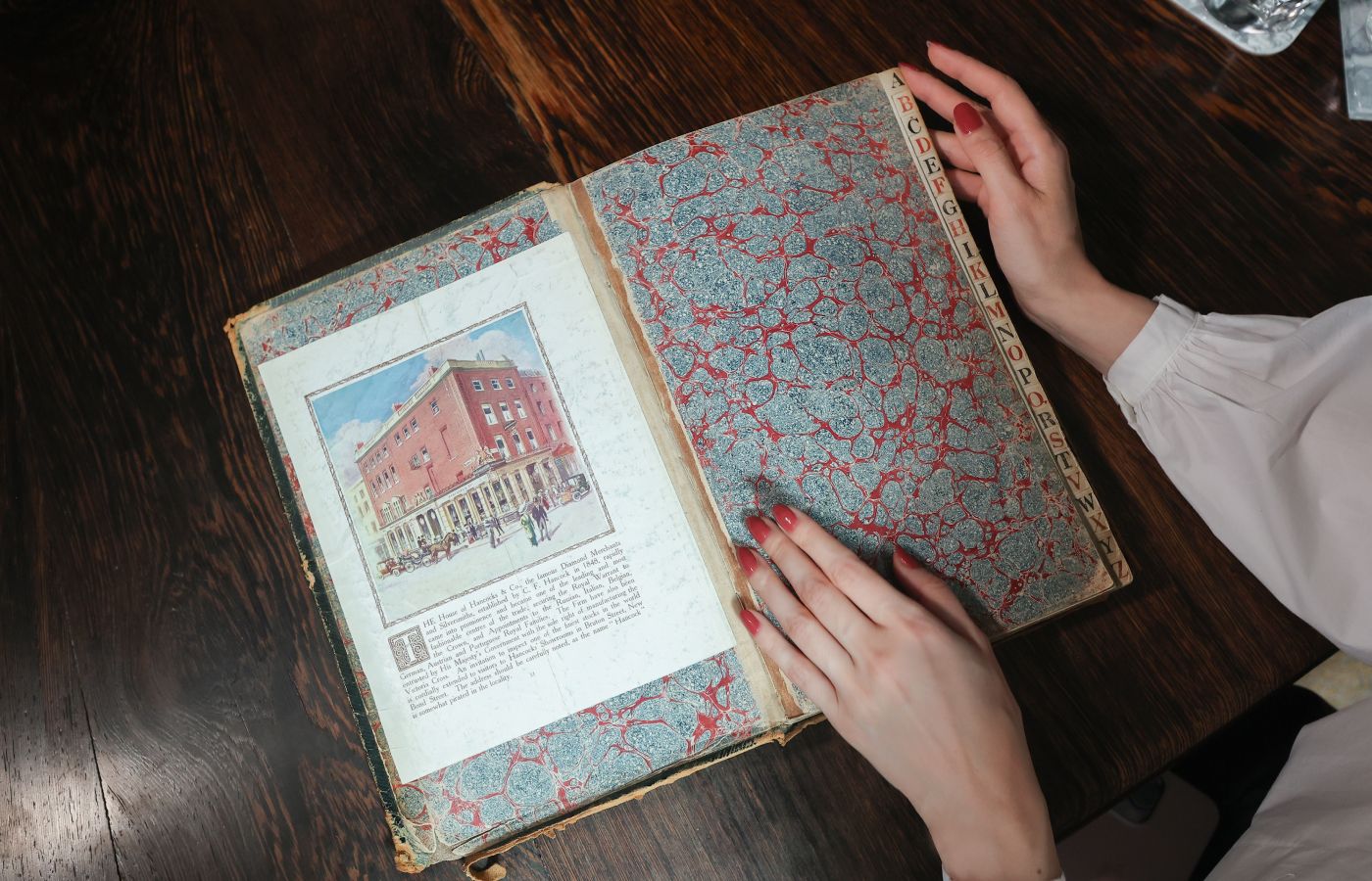 Katerina Perez looking through the historic Hancocks handwritten diary beginning in 1866