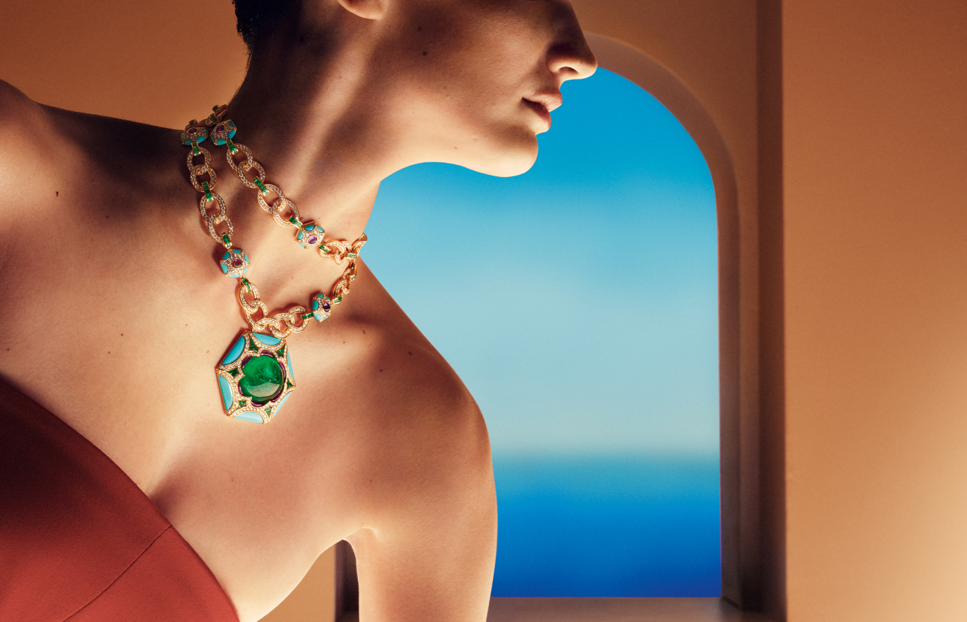 A model wears the Bulgari Roman Esedra sautoir from the Roman Splendor chapter of the Mediterranea High Jewellery collection with a 68.88-carat emerald cabochon, amethysts, turquoises, further emeralds and diamonds 