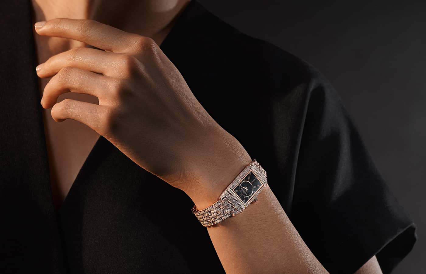 Model wearing Jaeger-LeCoultre Reverso Classic Small Duetto watch with a pink gold and diamond case and black dial 
