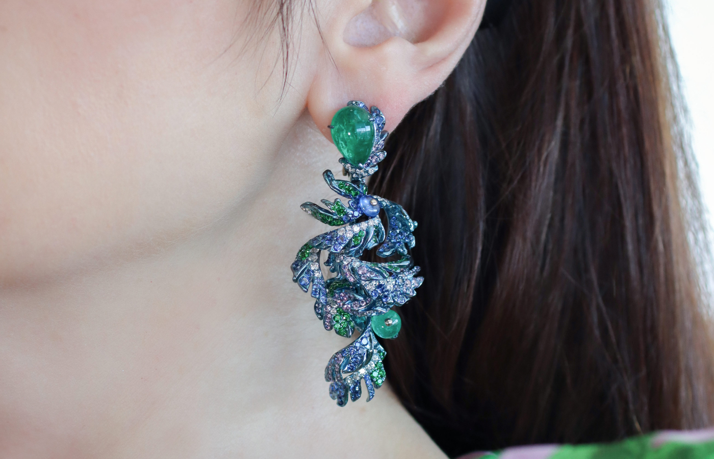 Katerina Perez wearing the Pavona earrings in emerald, multicoloured gemstones and diamond by Neha Dani 