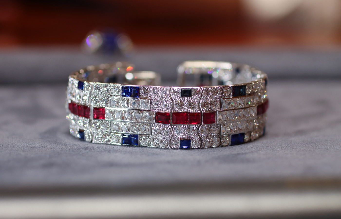An Art Deco diamond, ruby and sapphire bracelet by Cartier, circa 1930, presented by Ronald Abram