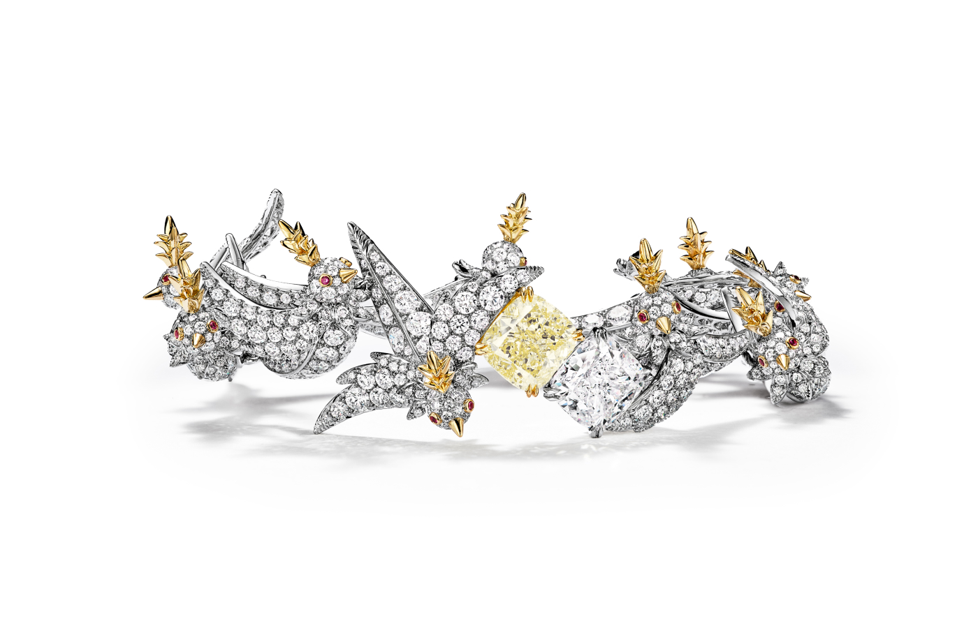  Close up of Tiffany & Co. Bird on a Rock necklace in gold, white gold, ruby, featuring yellow and white diamonds 