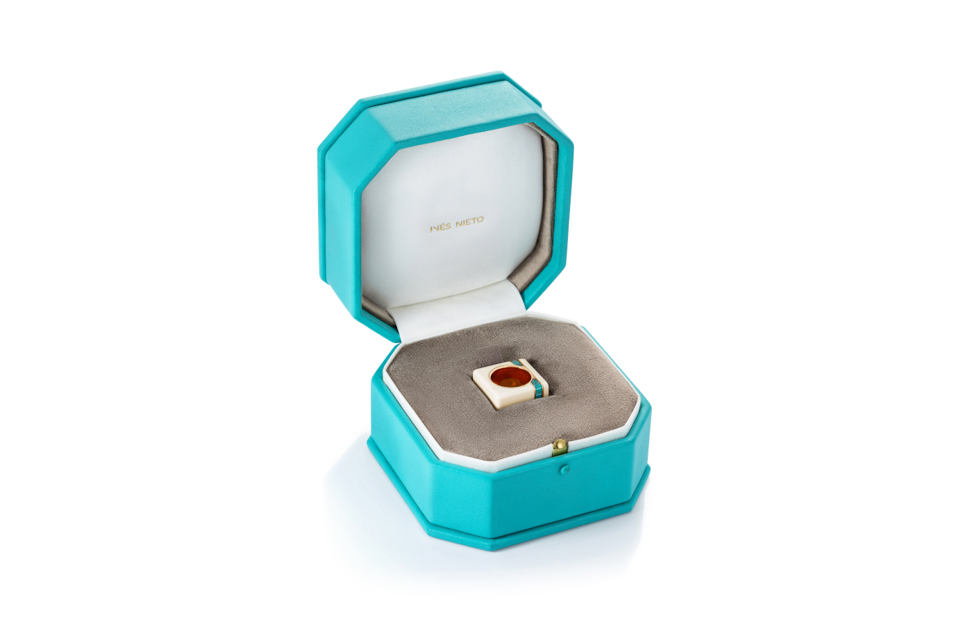  Inés Nieto presents her Paraiba tourmaline, white cacholong and rose gold Cube ring in distinctive ocean blue packaging