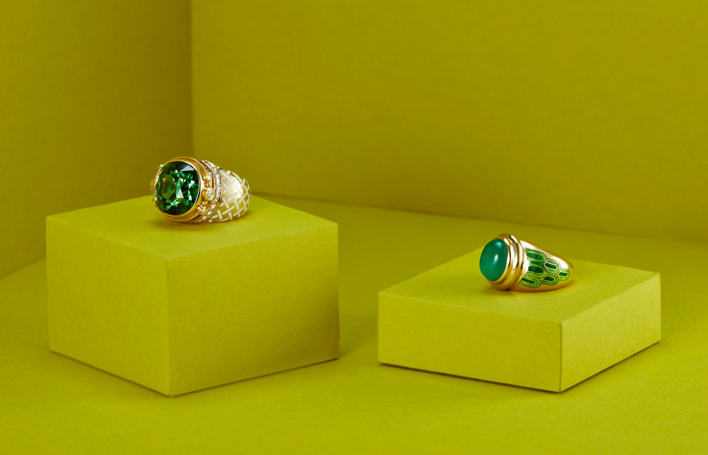 Elizabeth Gage Emerald Peacock ring in gold, enamel and emerald, alongside the Mint Green Tourmaline Charlemagne ring in gold, tourmaline and diamond