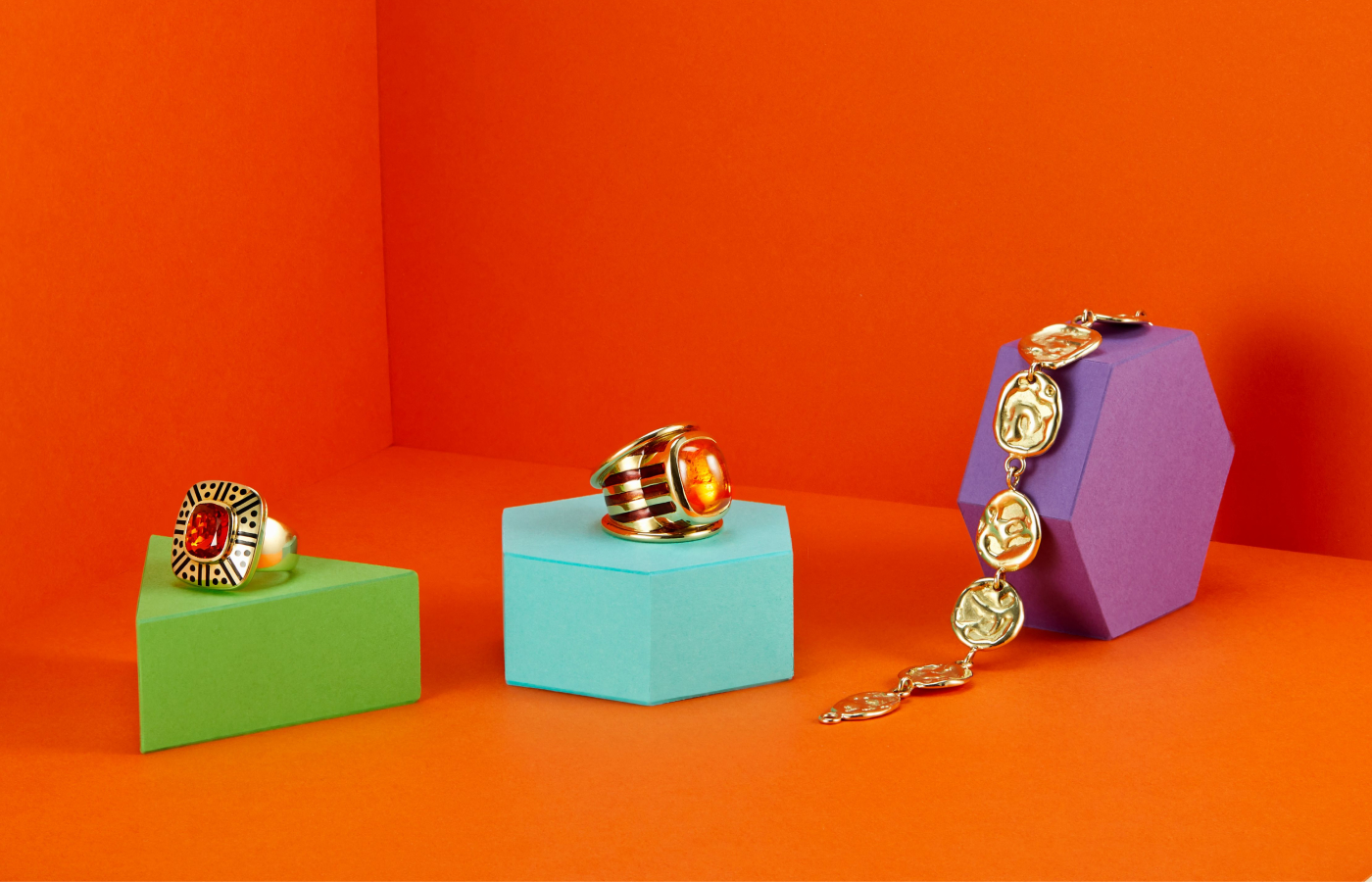  Elizabeth Gage Fire Opal ring in gold, enamel and fire opal, the The Aramis ring in gold, enamel and garnet, as well as the Molten Gold bracelet in gold