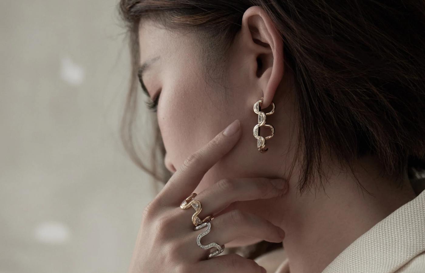 Model wearing State Property Edessa rings and earrings in gold, white gold and diamond
