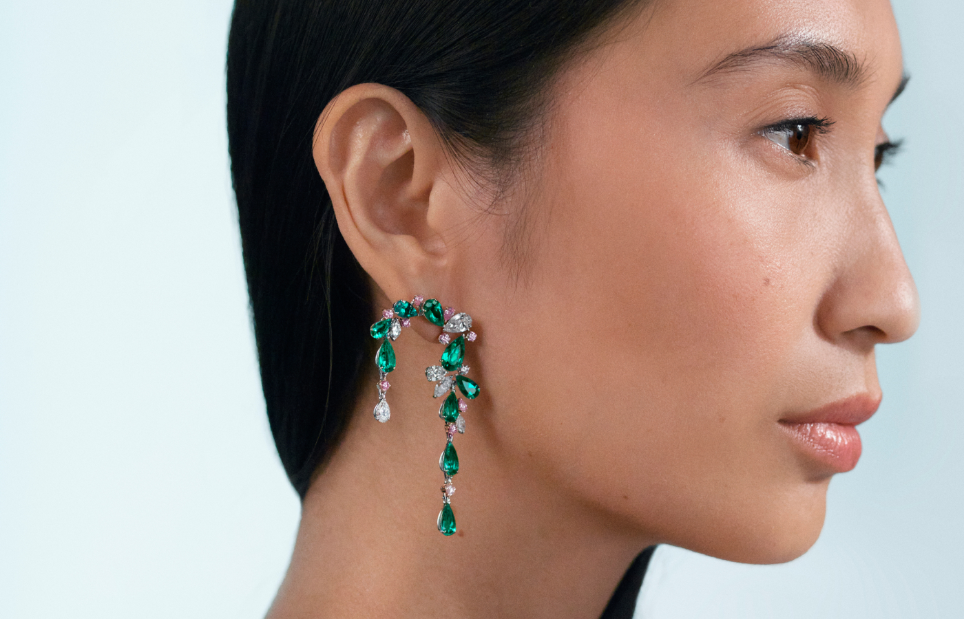 Model wearing Muzo Emerald Colombia Maya earrings in gold platinum, platinum, Muzo Emeralds, Argyle pink diamonds and white diamonds from the Green Jewel Tradition collection 