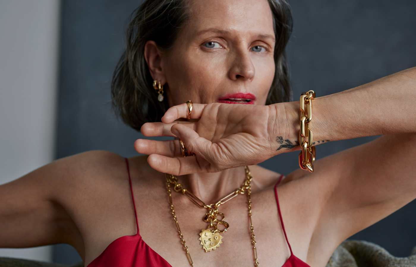  A model wears a Custom Heart Love Token medallion and other pieces by Foundrae