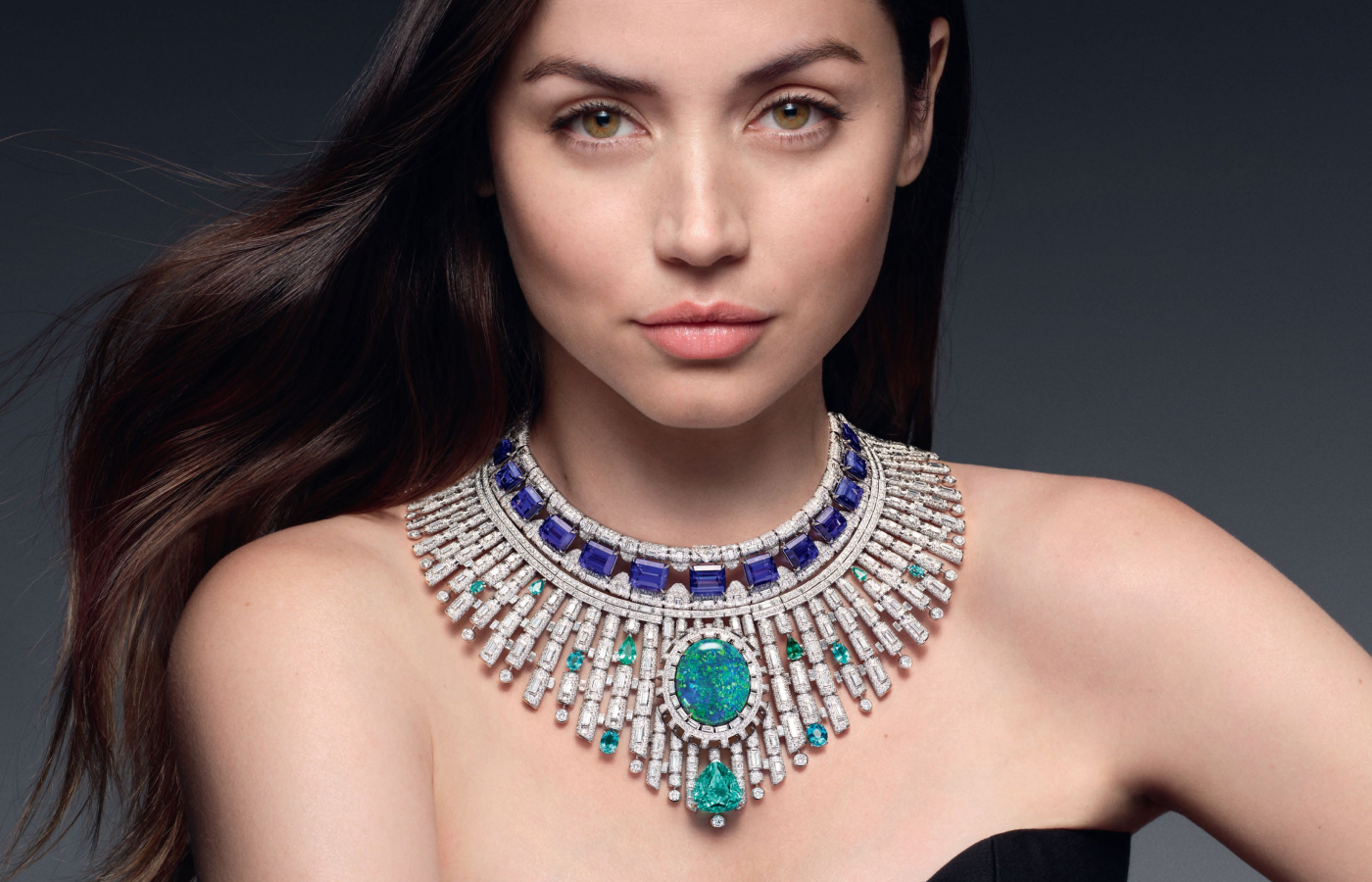 Actress Ana de Armas wearing the Louis Vuitton Bones transformable necklace in white gold, platinum, opal, Paraiba tourmaline, thirteen emerald-cut tanzanites for 91.74-cts from, tourmaline and diamond from the Deep Time high jewellery collection