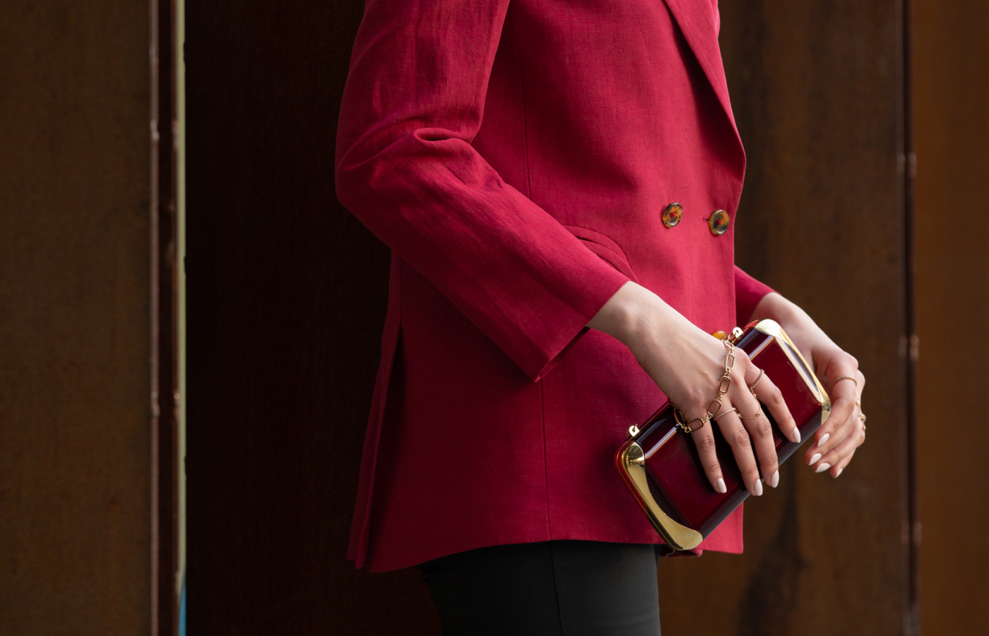 Model holding a Misahara x Jeffrey Levinson Clutch bag